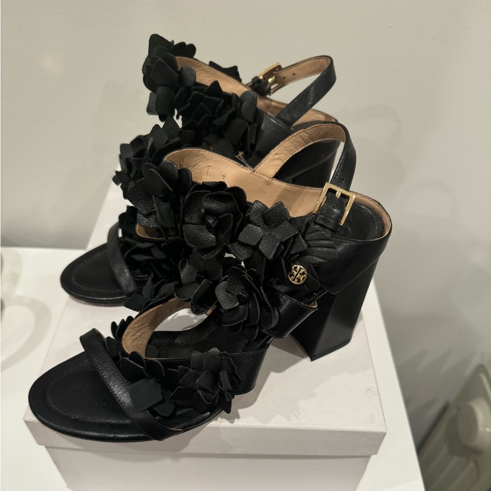 Tory Burch black heels with floral detail.